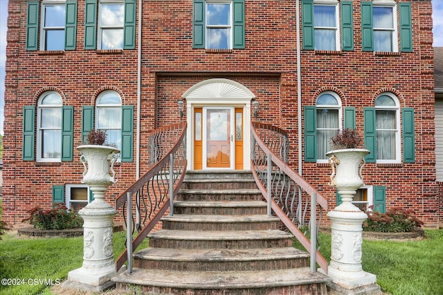 property entrance with brick siding