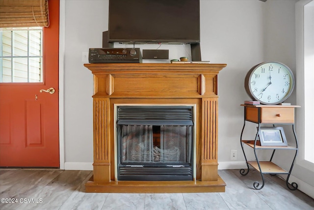 room details with baseboards and a glass covered fireplace