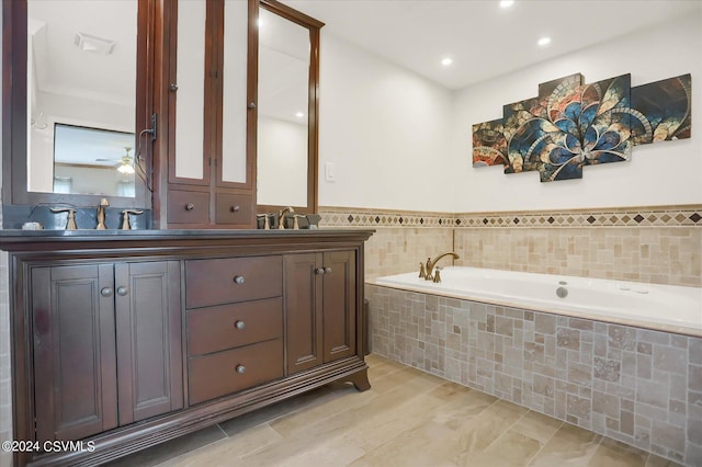 bathroom featuring a bath, double vanity, a sink, and a ceiling fan
