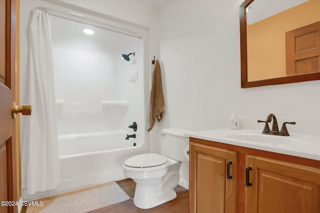 bathroom featuring toilet, shower / tub combo with curtain, and vanity
