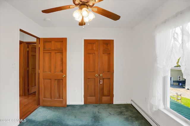unfurnished bedroom with ceiling fan, a baseboard heating unit, and dark colored carpet