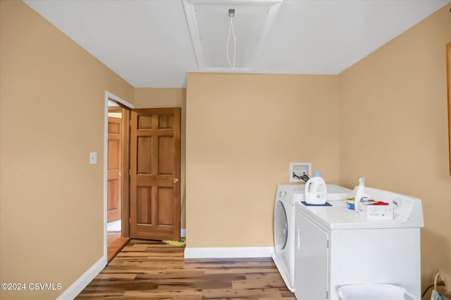 laundry area with washer and dryer, light wood finished floors, laundry area, and baseboards