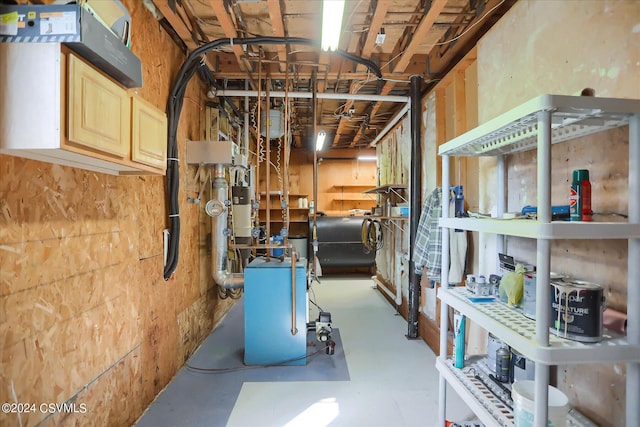 unfinished below grade area with a heating unit and heating fuel