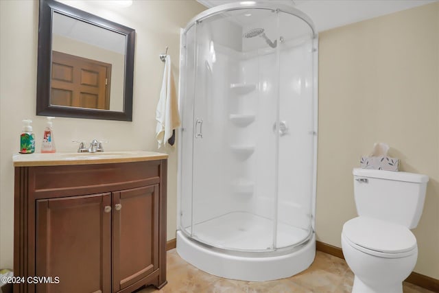 full bath featuring a shower stall, vanity, baseboards, and toilet