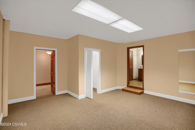 unfurnished room with baseboards and carpet floors