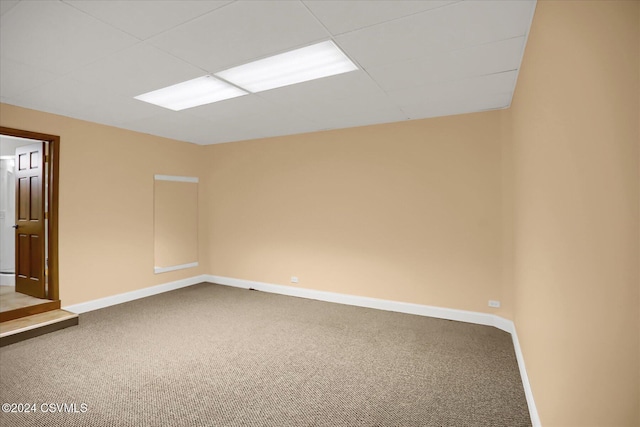 carpeted empty room featuring baseboards