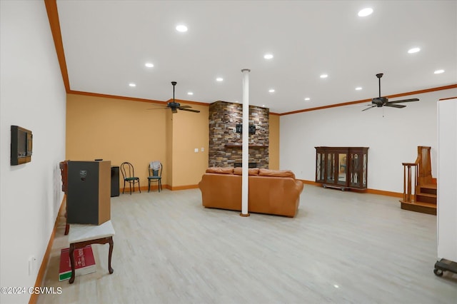 living room with light wood finished floors, crown molding, ceiling fan, and baseboards