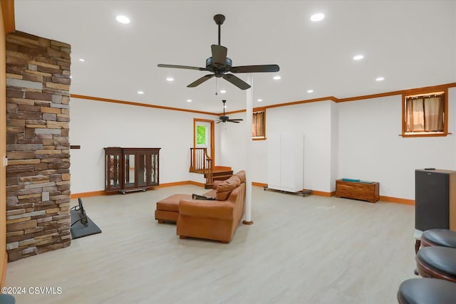 living area with crown molding, wood finished floors, ceiling fan, and baseboards