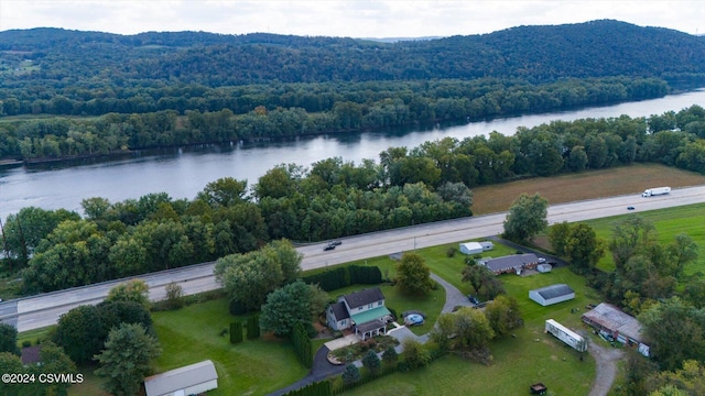drone / aerial view featuring a forest view and a water view