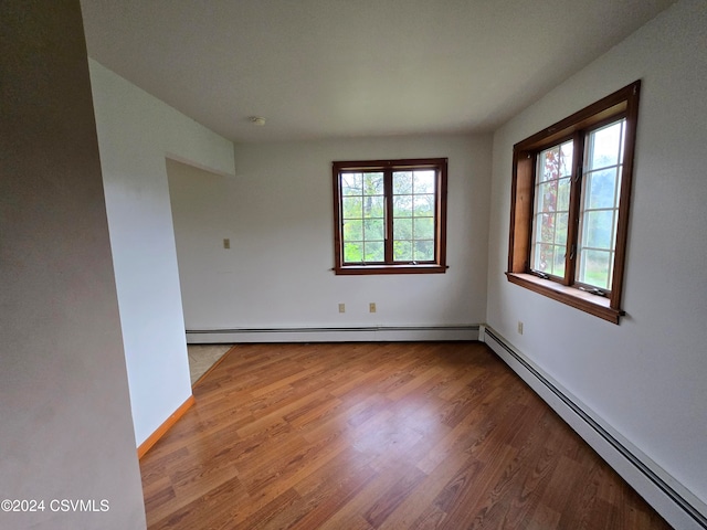 spare room featuring light hardwood / wood-style floors and baseboard heating