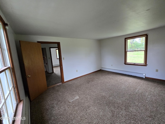 carpeted empty room with baseboards and a baseboard radiator