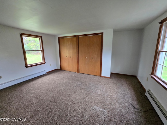 unfurnished bedroom with a baseboard radiator and light colored carpet