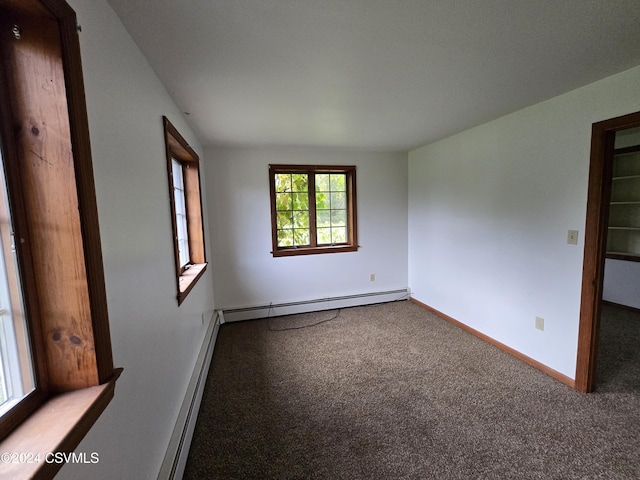 carpeted spare room featuring baseboards and baseboard heating
