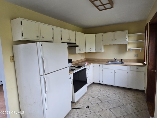 kitchen featuring open shelves, a sink, freestanding refrigerator, under cabinet range hood, and range with electric stovetop