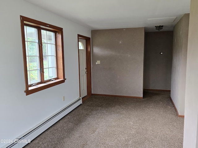 empty room featuring carpet, baseboards, and baseboard heating