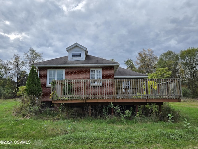 rear view of property with a wooden deck and brick siding