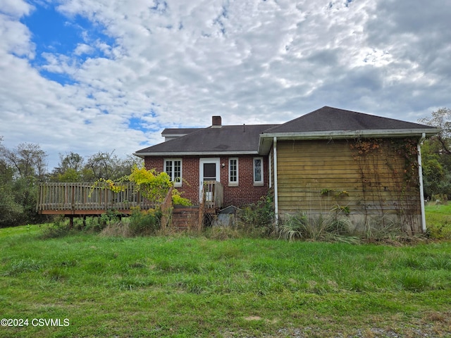 rear view of house with a wooden deck