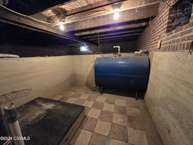 unfinished basement featuring heating fuel