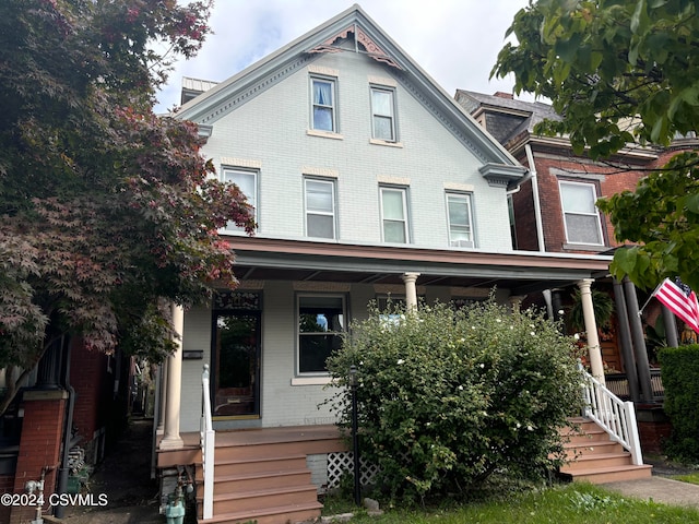 victorian house featuring a porch