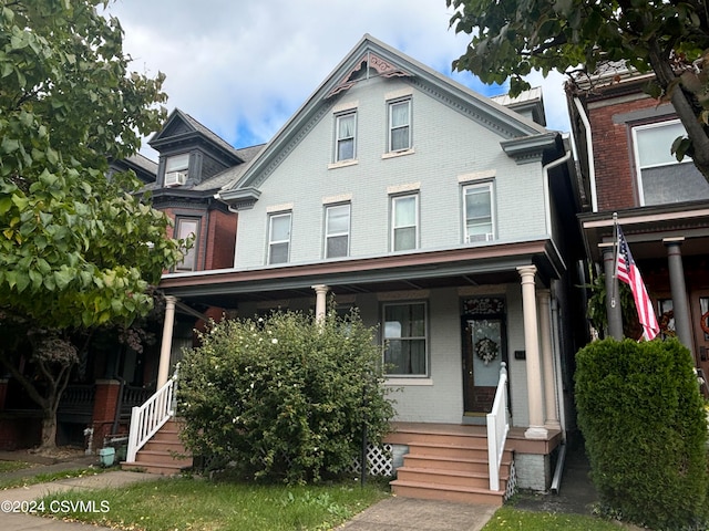 victorian house featuring a porch