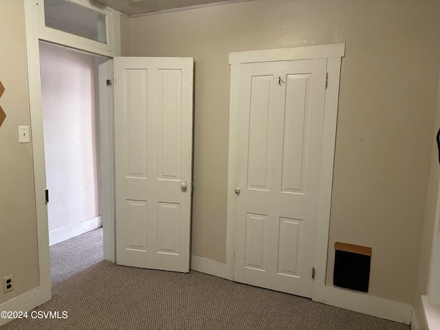 unfurnished bedroom featuring light carpet