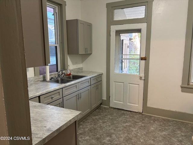 kitchen featuring gray cabinets and sink