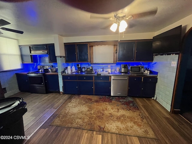 kitchen featuring extractor fan, ceiling fan, dark wood-type flooring, sink, and appliances with stainless steel finishes