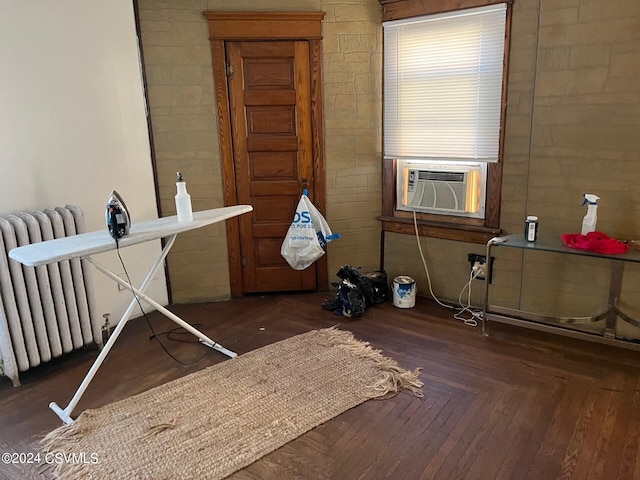 miscellaneous room featuring dark parquet flooring, cooling unit, and radiator