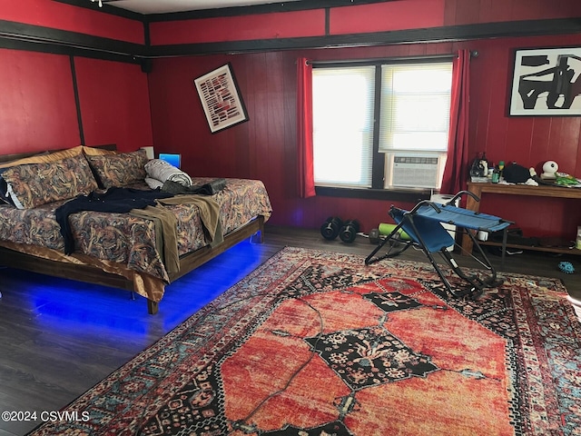 bedroom with cooling unit and wood-type flooring