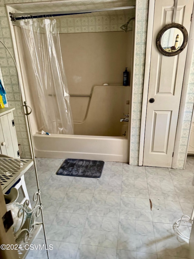 bathroom featuring shower / tub combo and vanity