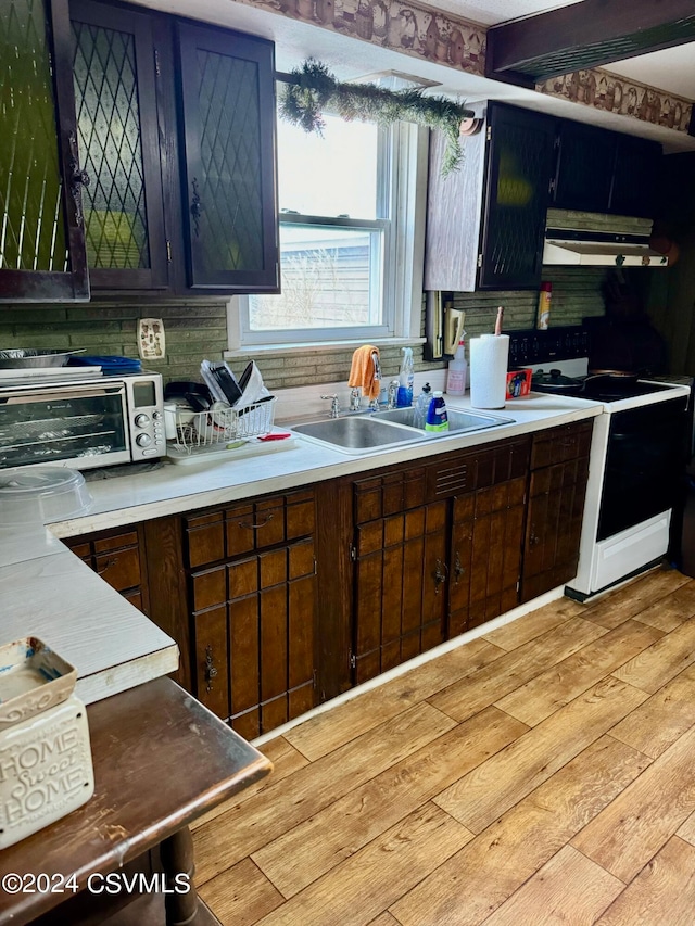 kitchen with white range with electric stovetop, sink, and light hardwood / wood-style flooring