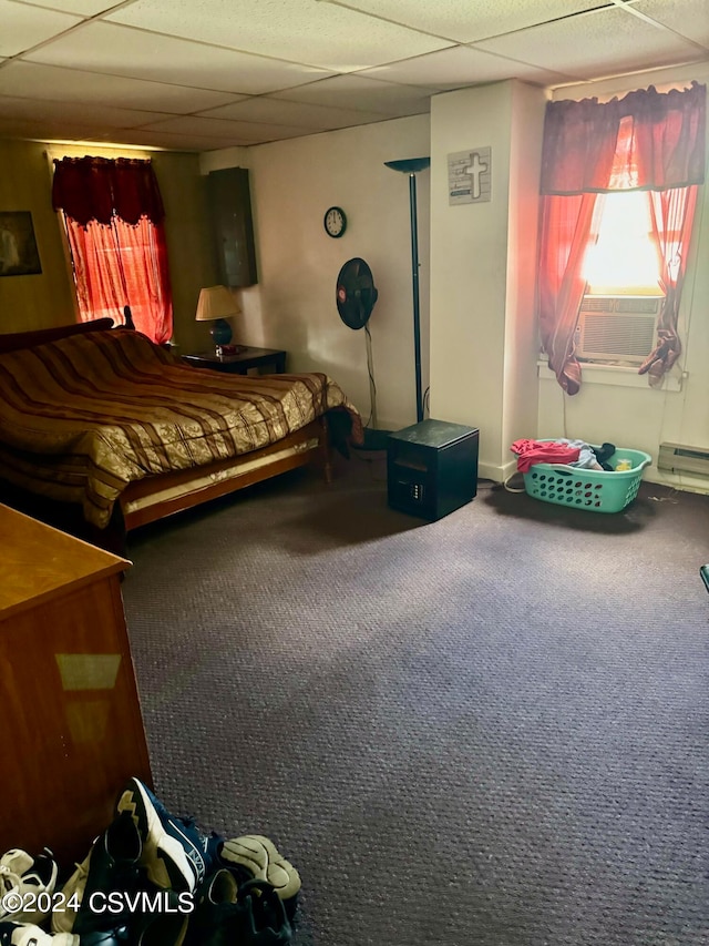 carpeted bedroom featuring cooling unit, a paneled ceiling, and baseboard heating