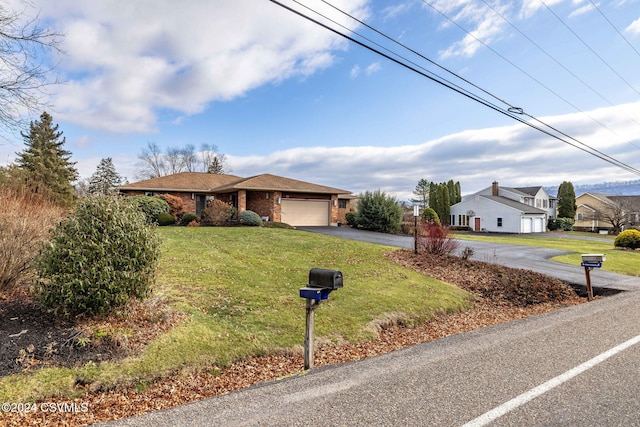 ranch-style home with a garage and a front yard