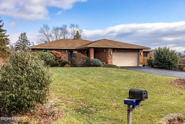 view of front of home with a front yard and a garage