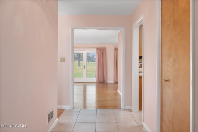 corridor featuring light hardwood / wood-style floors