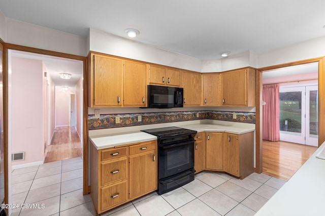 kitchen with black appliances and light wood-type flooring