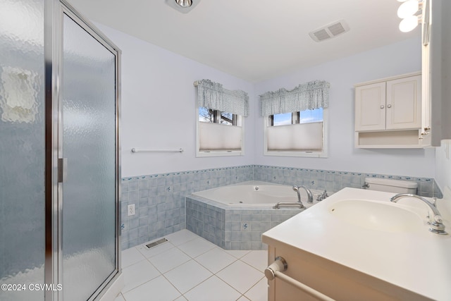 bathroom featuring shower with separate bathtub, vanity, tile patterned floors, and tile walls