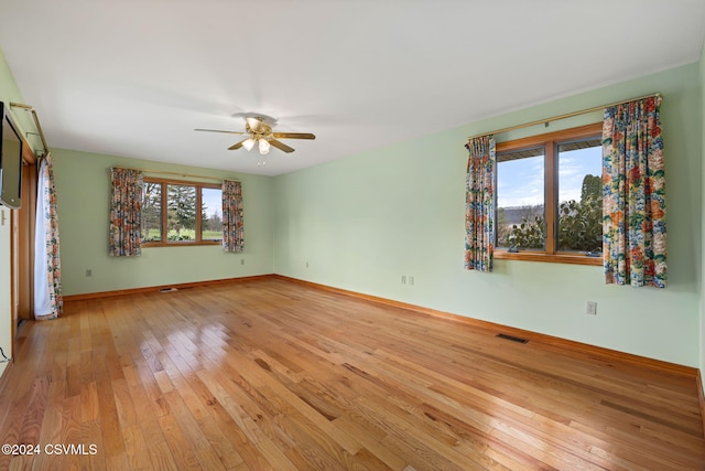 spare room with ceiling fan and light hardwood / wood-style flooring