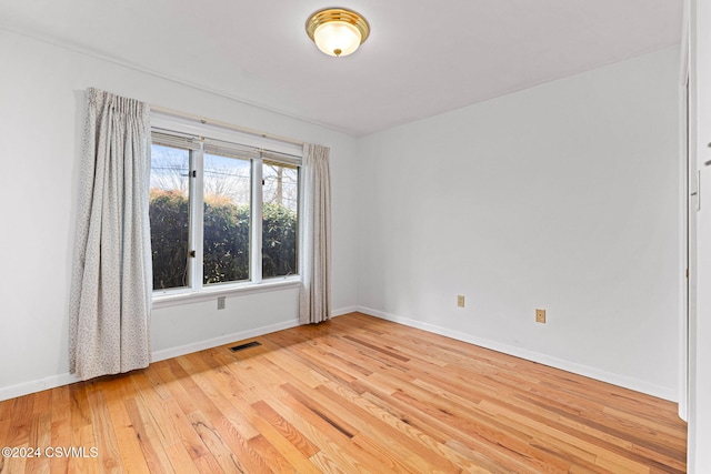 spare room featuring light hardwood / wood-style floors