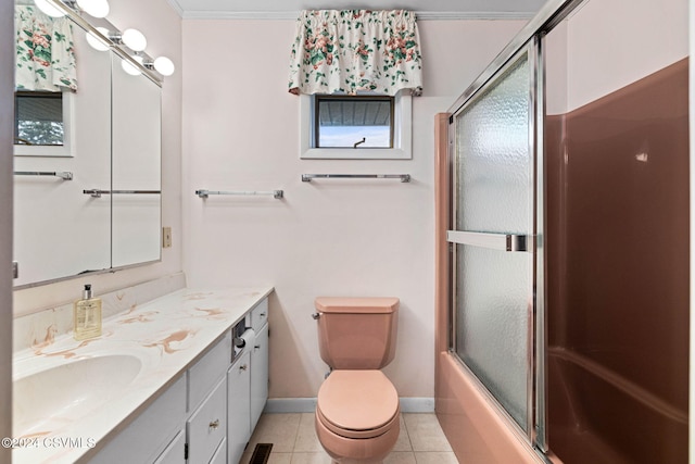 full bathroom with vanity, crown molding, enclosed tub / shower combo, tile patterned flooring, and toilet