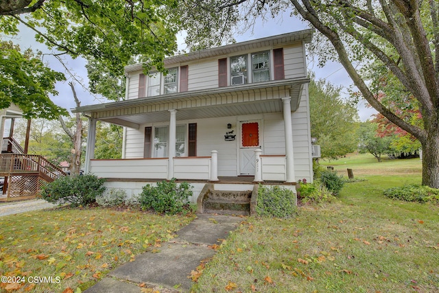 view of front facade with a front yard and covered porch