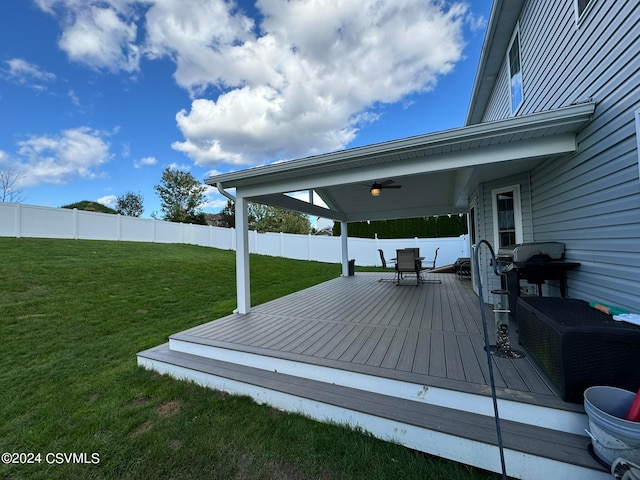 deck with a yard, area for grilling, and ceiling fan