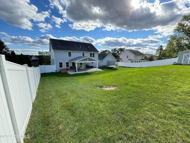 back of property featuring a yard and a patio