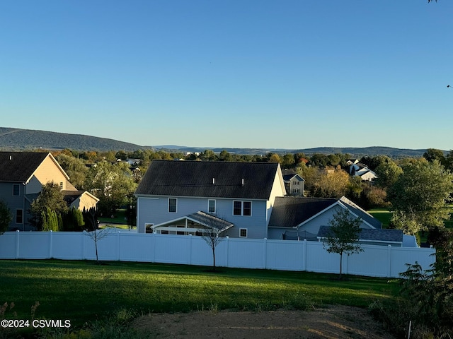 exterior space featuring a mountain view and a lawn