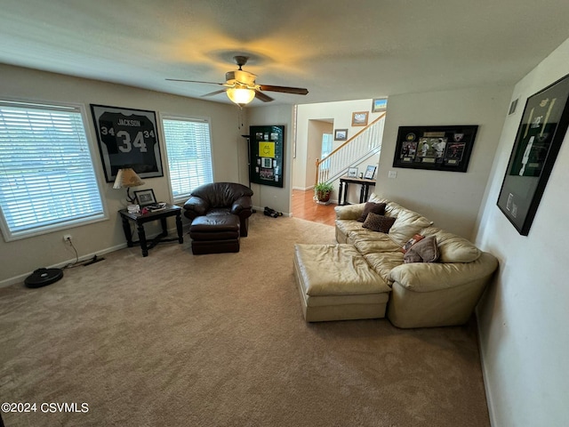 carpeted living room with ceiling fan