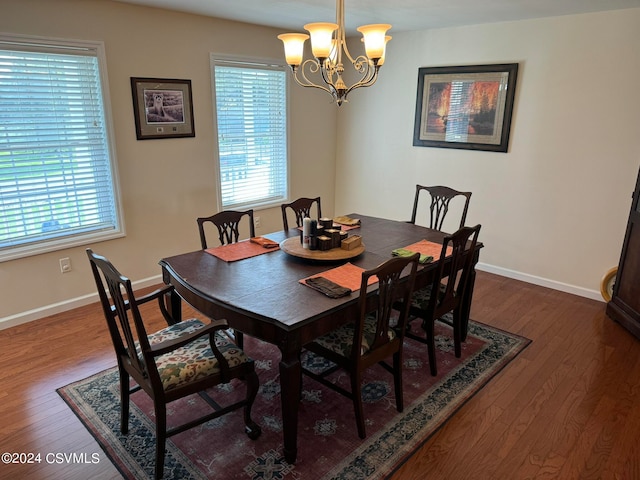 dining space with a chandelier and dark hardwood / wood-style flooring