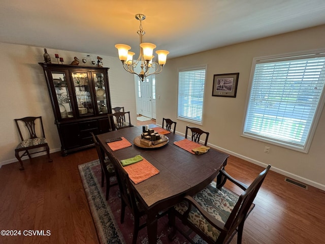 dining room featuring a notable chandelier and dark hardwood / wood-style flooring