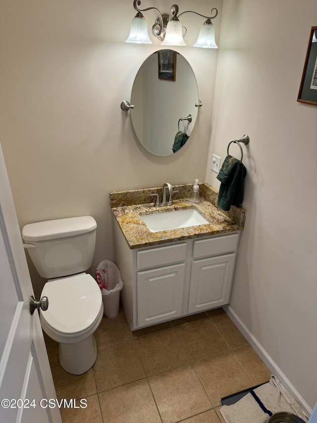 bathroom featuring vanity, tile patterned flooring, and toilet