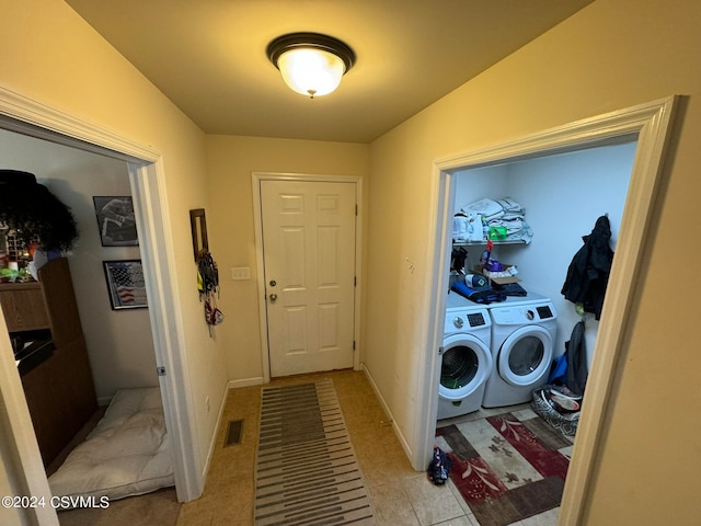 washroom with washing machine and dryer and light tile patterned floors