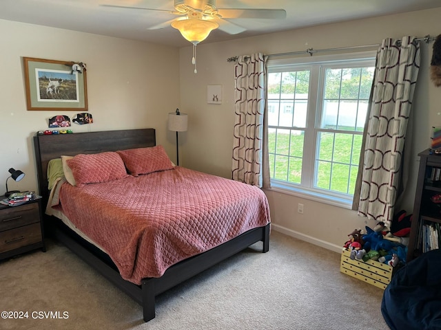 carpeted bedroom with multiple windows and ceiling fan